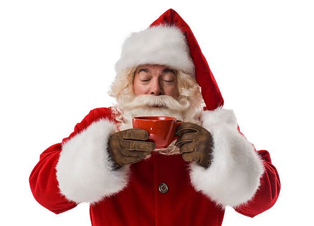 père noël bois une boisson chaude - Istock
