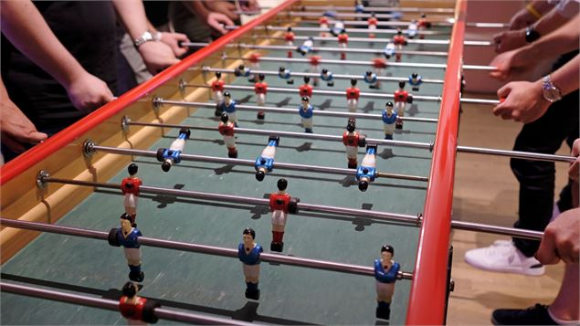 babyfoot avec des mains de jeunes en train de jouer - canva