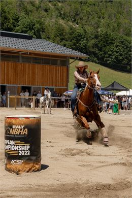 Une cavalière sur son cheval approche d'un tonneau pour en faire le tour - Flo Little Ranch