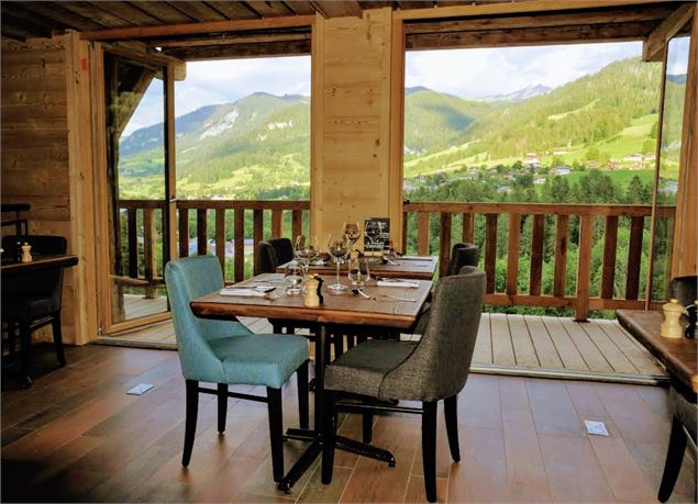 Table du restaurant devant une baie vitrée donnant sur les paysages verdoyants alentour - Fondation 