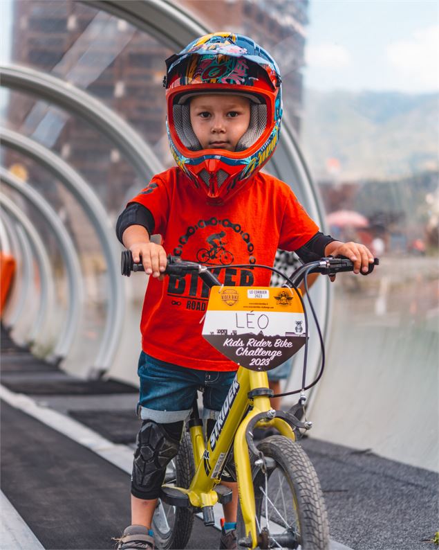Enfant en draisienne dans le tapis couvert du Corbier pour accéder au mini bike park - Office de Tou